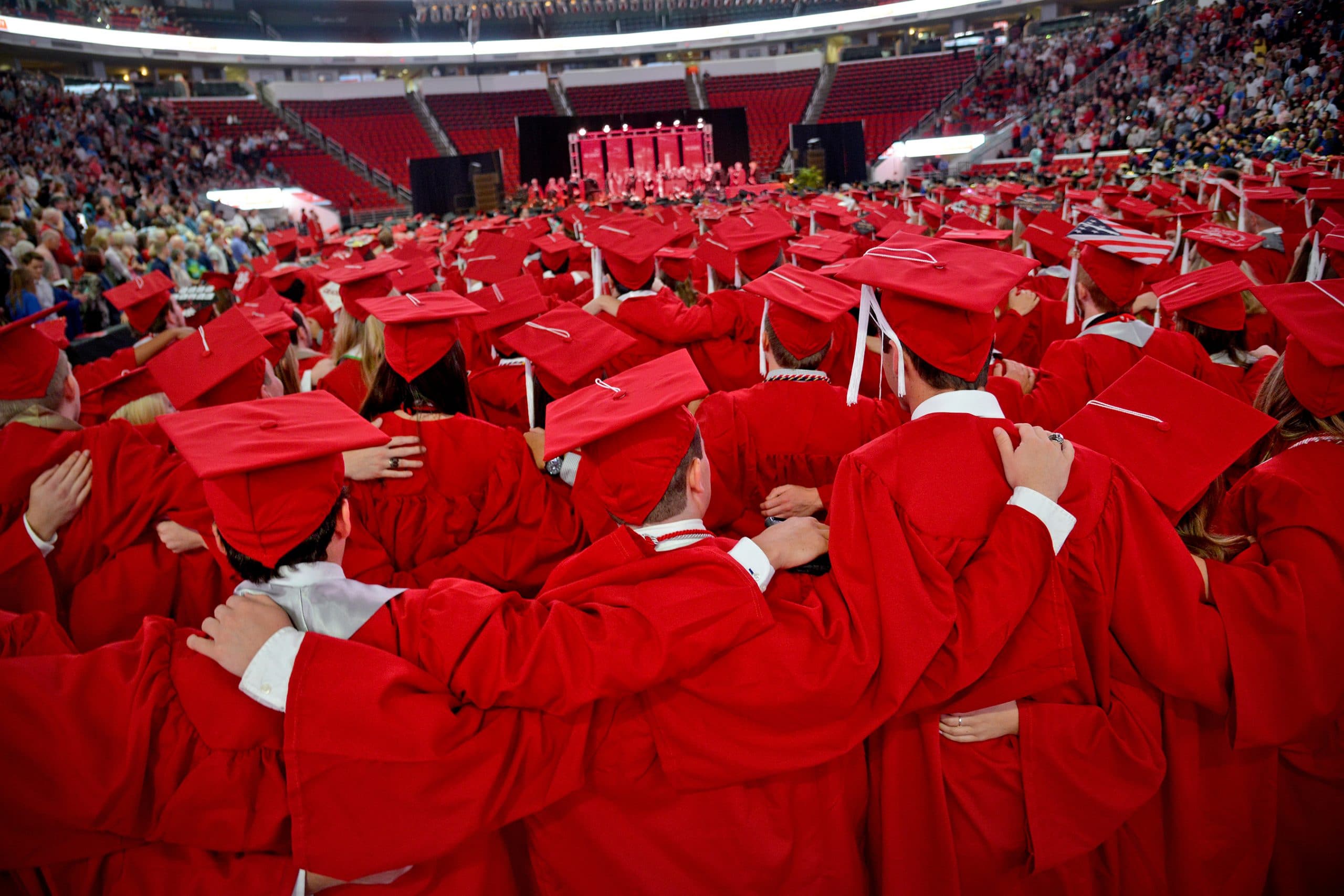 Students sing the Alma Mater at commencement