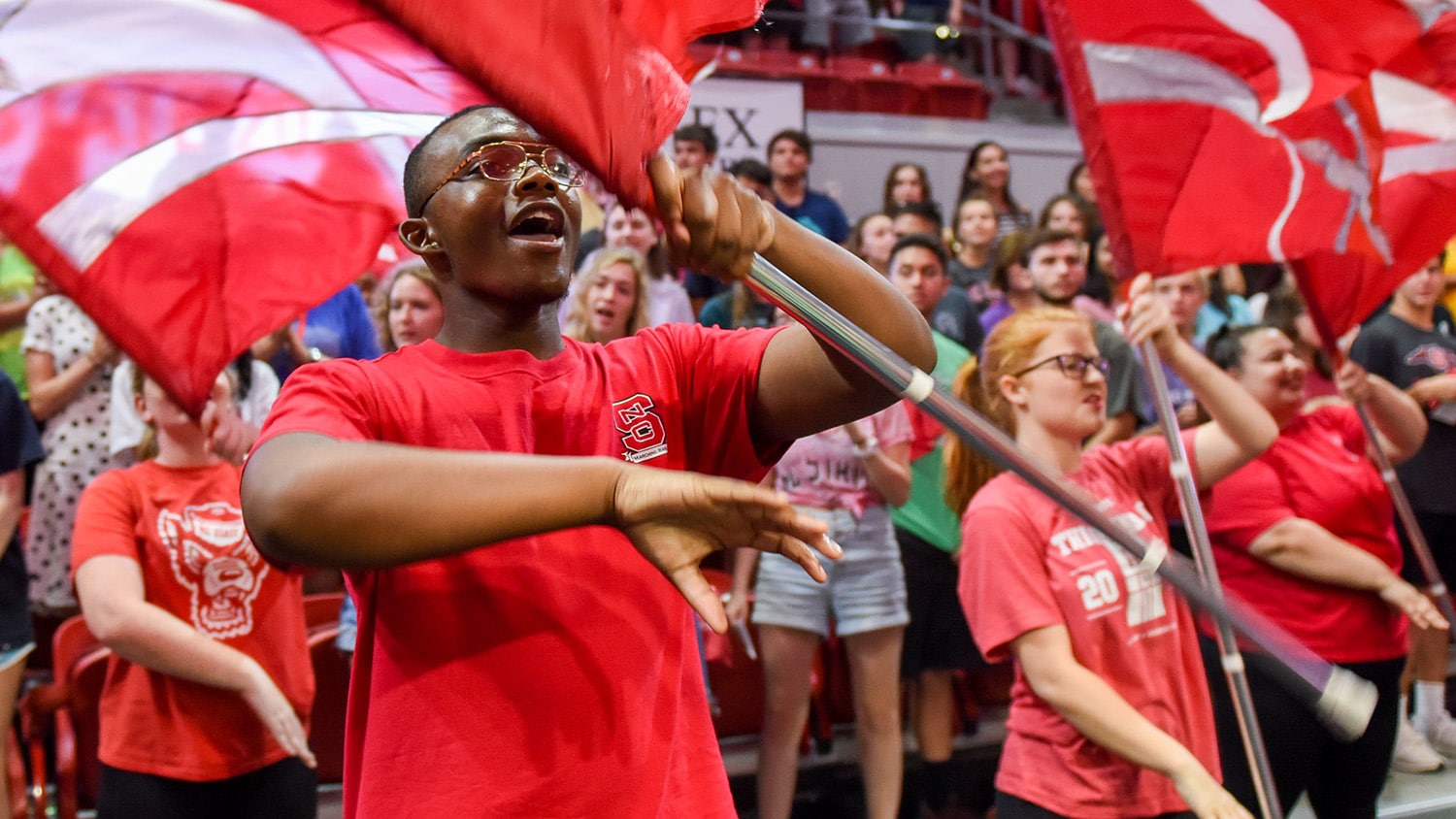 Student waving a flag at convocation.