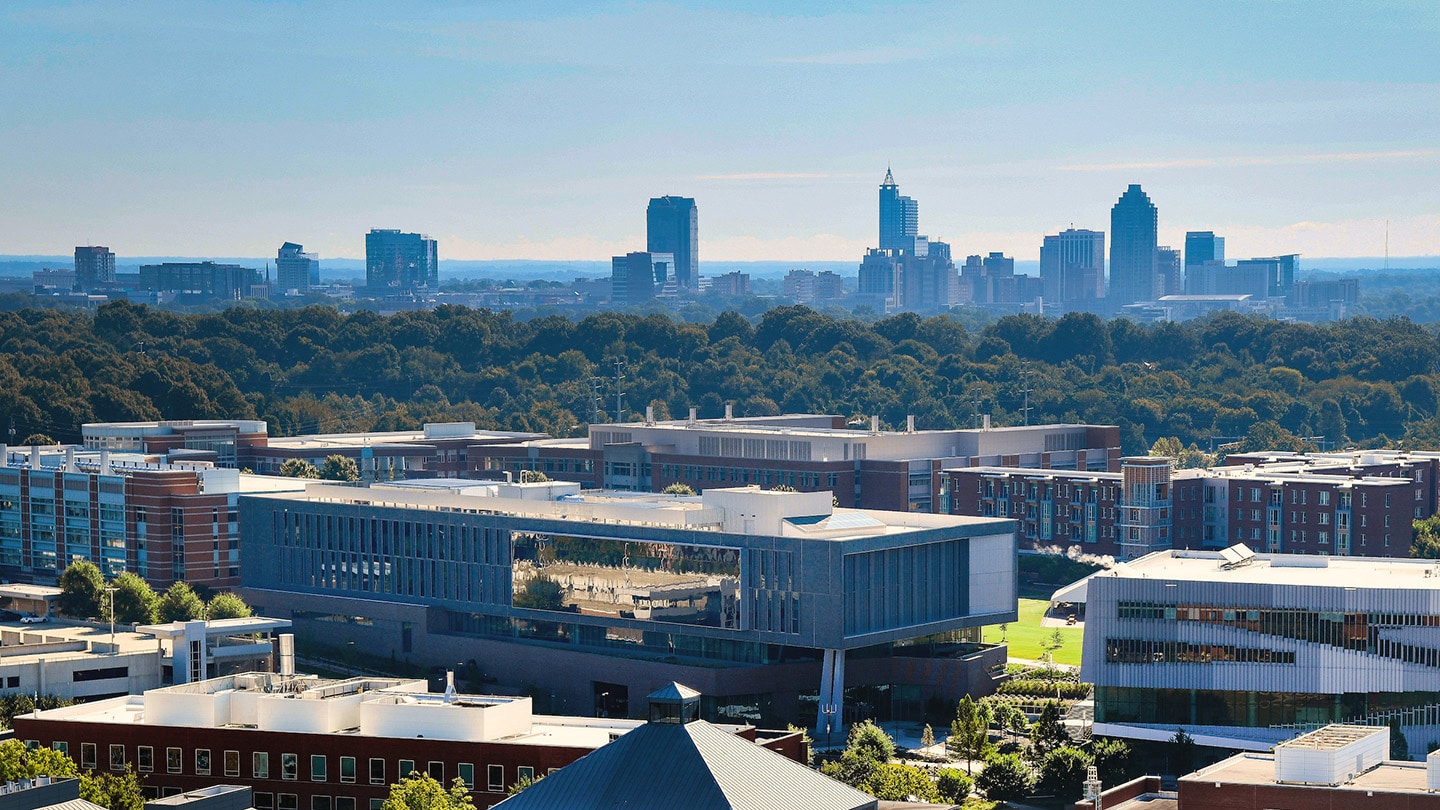 The Raleigh skyline is seen beyond NC State's Centennial Campus in an aerial photograph.