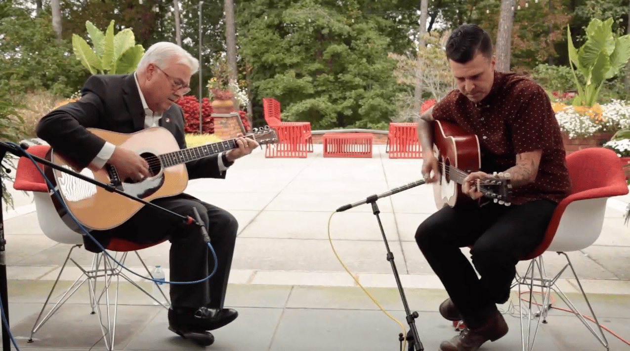 Chancellor Woodson and BJ Barham of the band American Aquarium play guitar together at the chancellor's residence.
