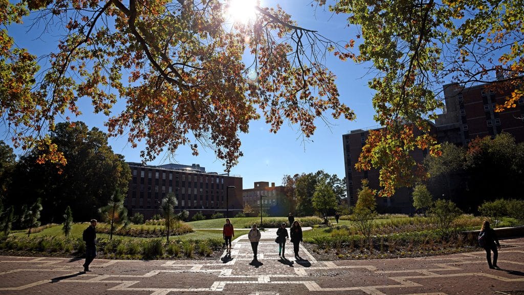 Students walk to class on North Campus at the Brickyard, near the space where Harrelson Hall once stood.
