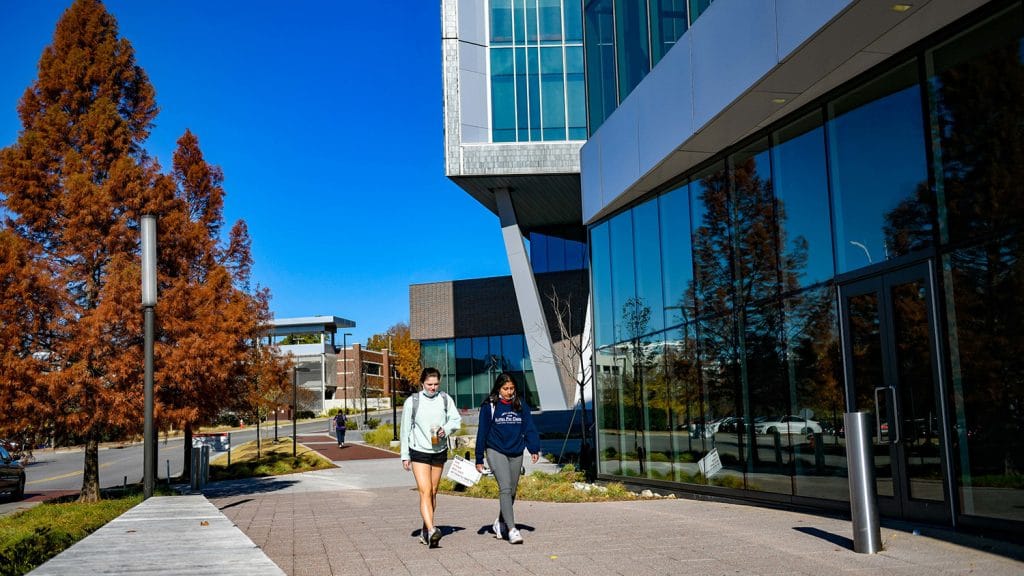 Students pass the newly completed Fitts-Woolard engineering building on their way to the Hunt Library entrance on Centennial Campus.