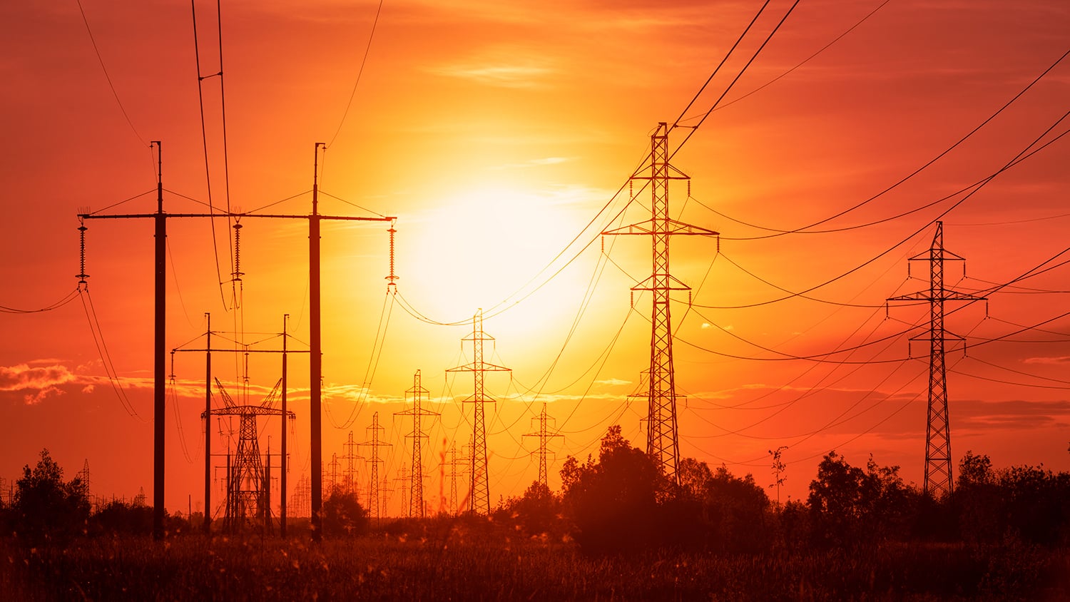 Power lines on a background of sunset in disturbing red tones