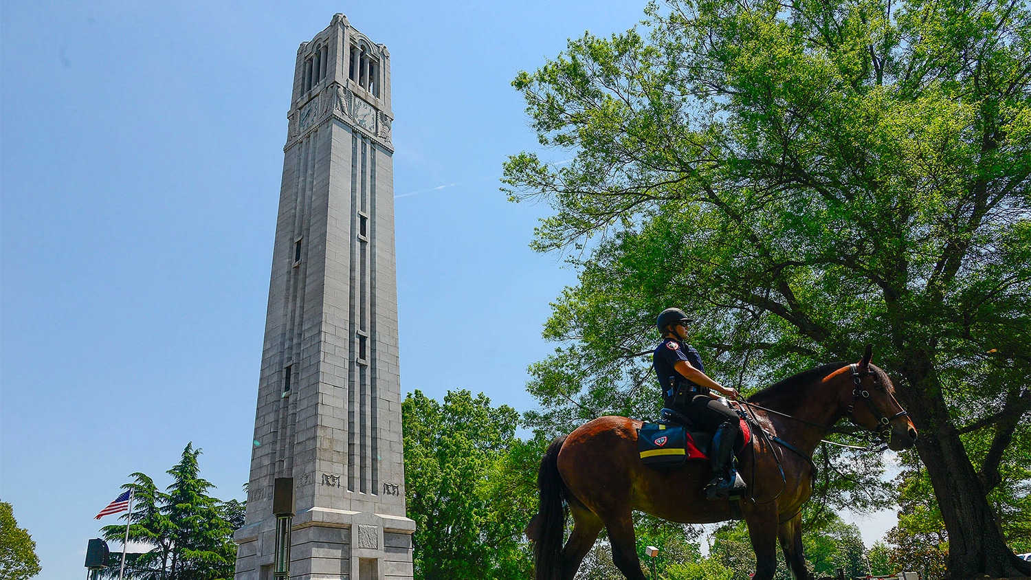 NC State mounted police in front of the Memorial Belltower