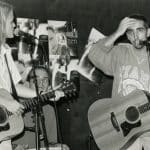 Singer/songwriter Mary Karlzen performs with a guitar player and a percussionist in this black and white archival photo.