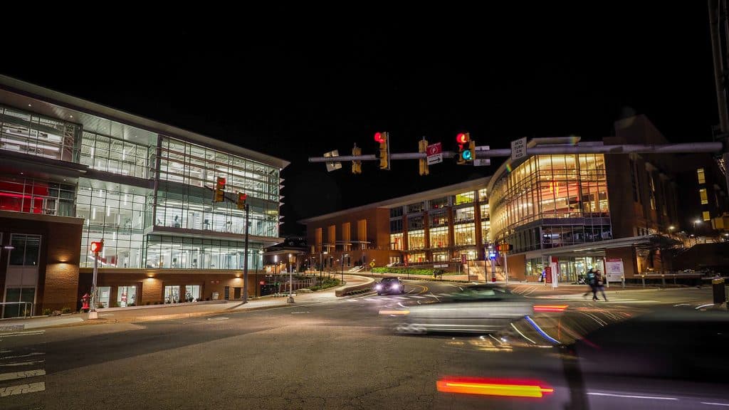 An exterior view of Talley Student Union, lit at night with shining lights.