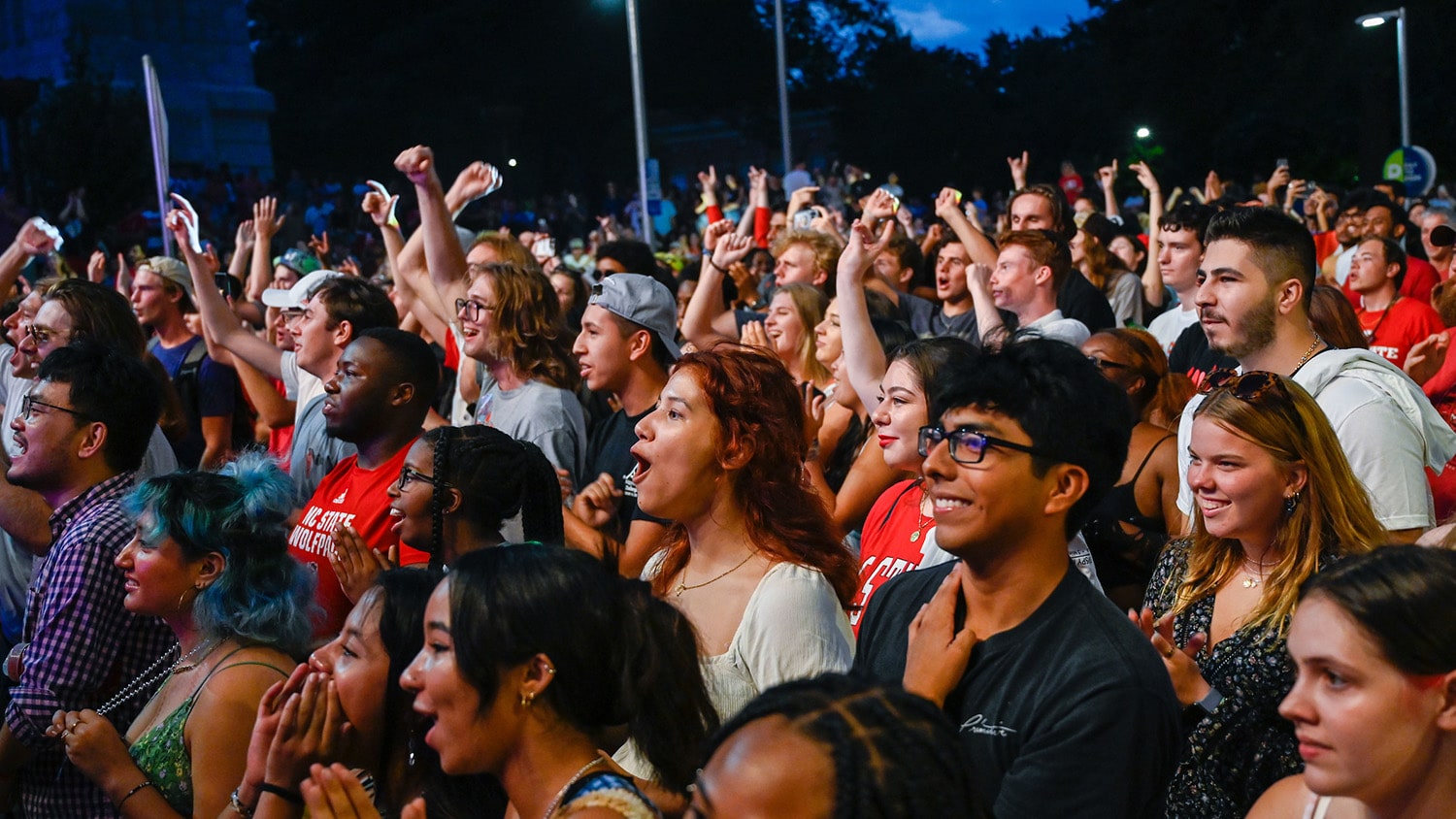 A crowd of excited students watch a performance on the Packapalooza main stage.