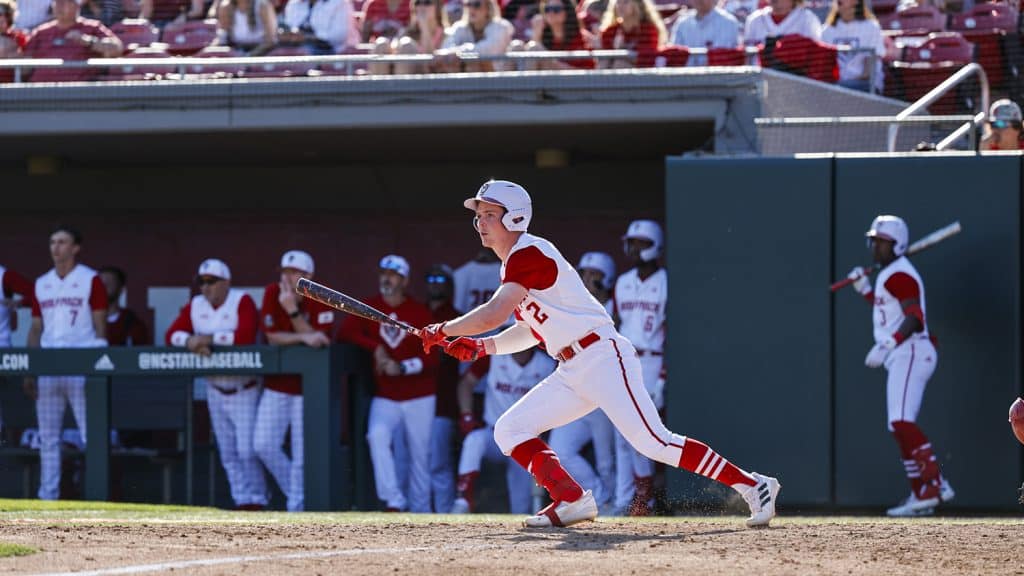 Chase Nixon, batting for NC State, prepares to run to first base.