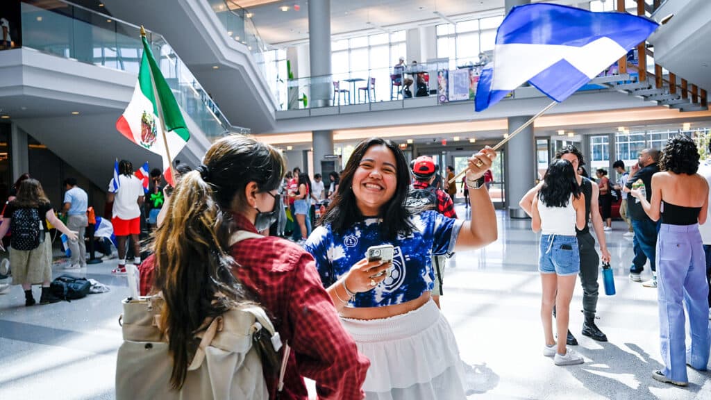 Students wave the Nicaraguan and Mexican flags in Talley Student Union.