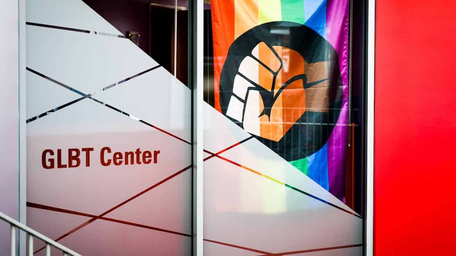 The GLBT Center entrance with a rainbow fist flag.