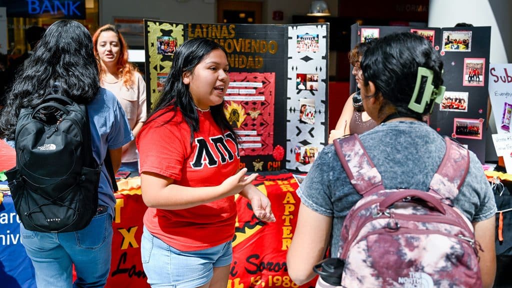 Students promote Latinx organizations at a tabling event for Latinx Heritage Month.