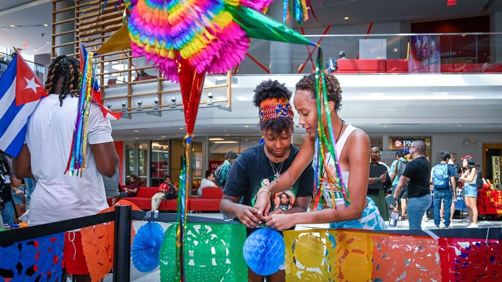 Students prepare the piñata area at an event for Latinx Heritage Month.
