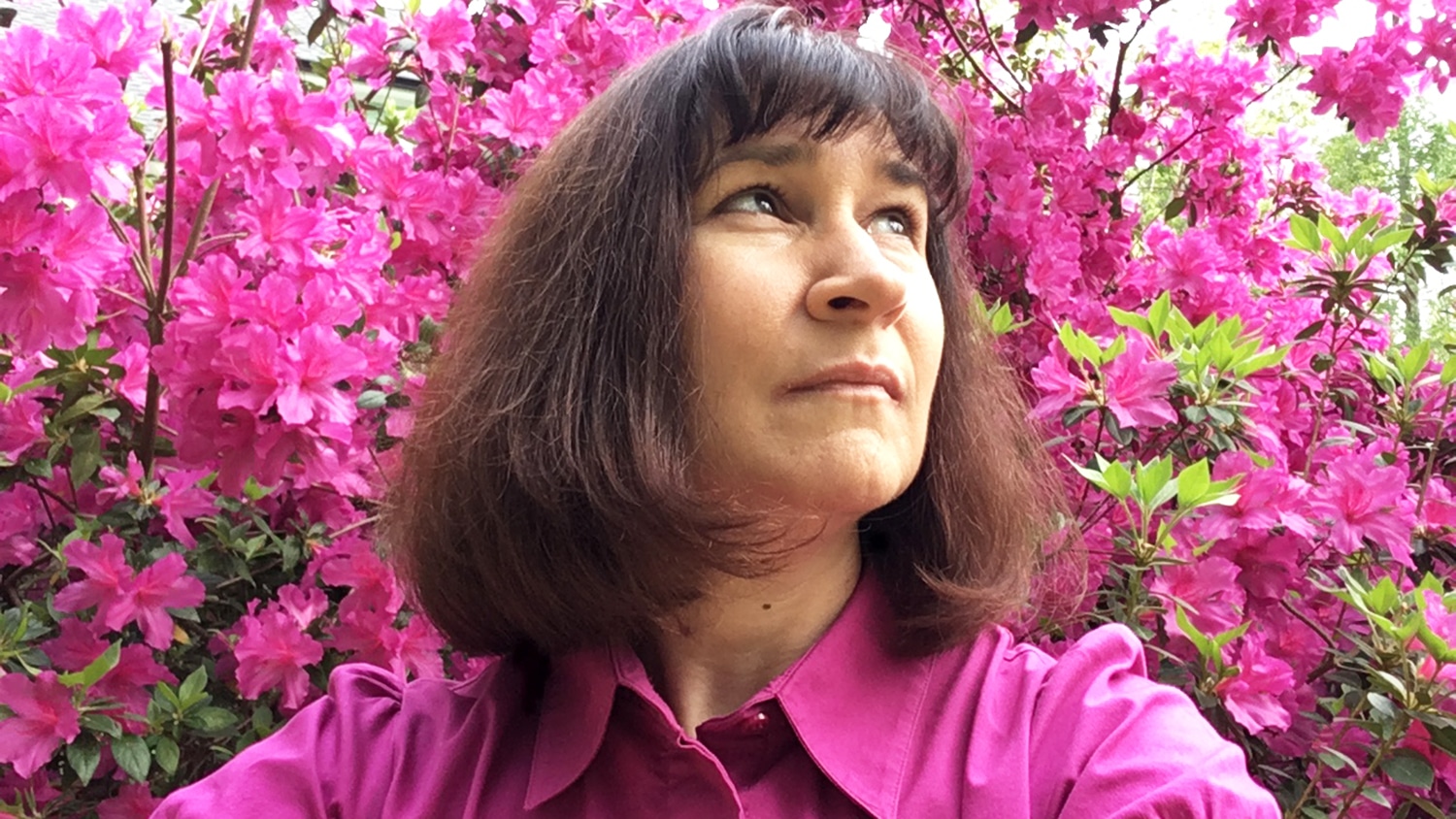 Anne Lesky headshot against backdrop of bright pink azaleas