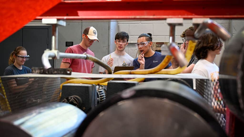 Students observing processing equipment.