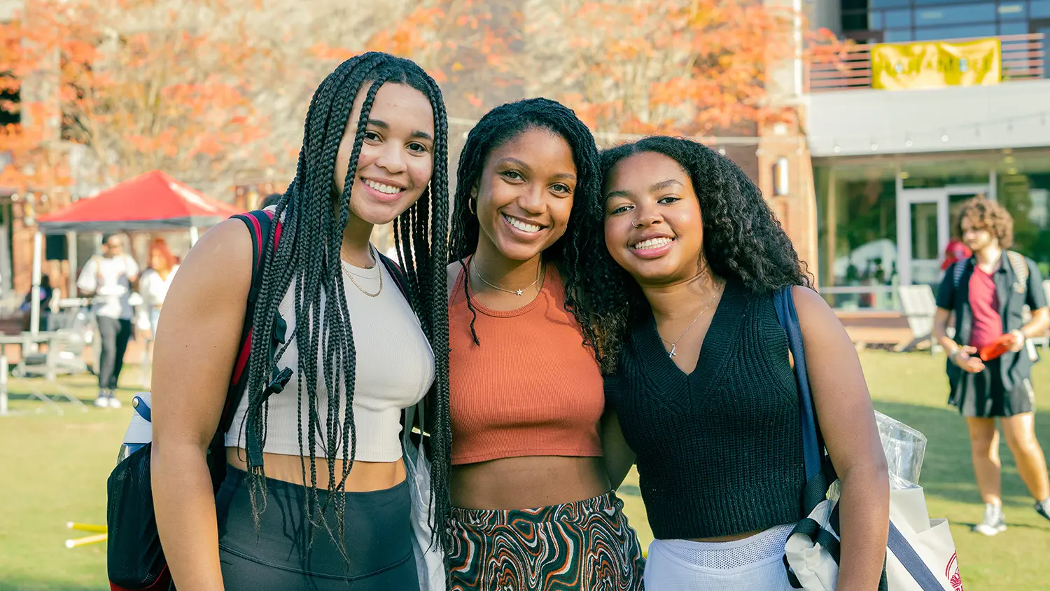 Three students pose together outside of WItherspoon Student Center during Harambee.