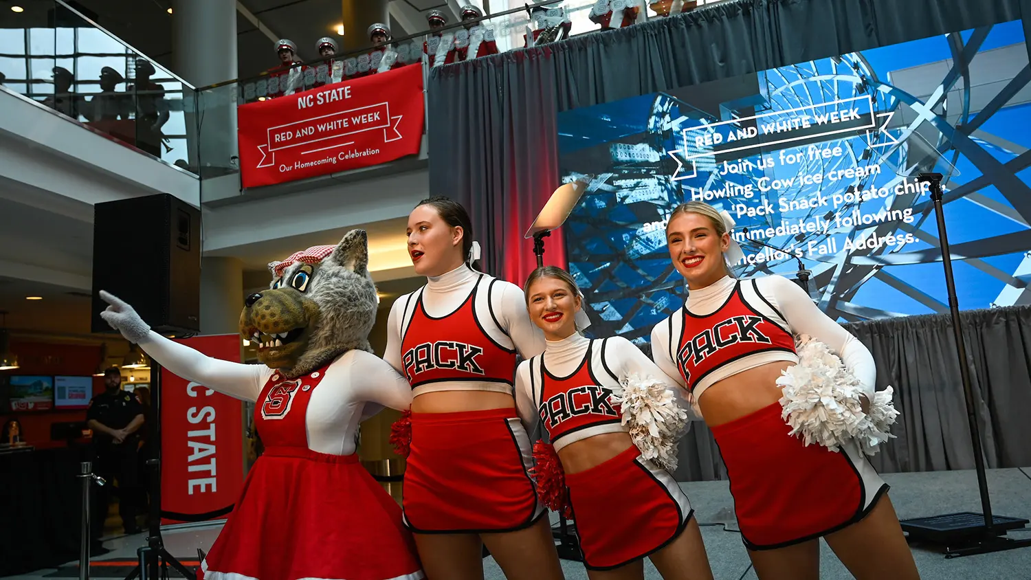 Cheerleaders lead the crowd in singing the alma mater during a Red and White Week event.