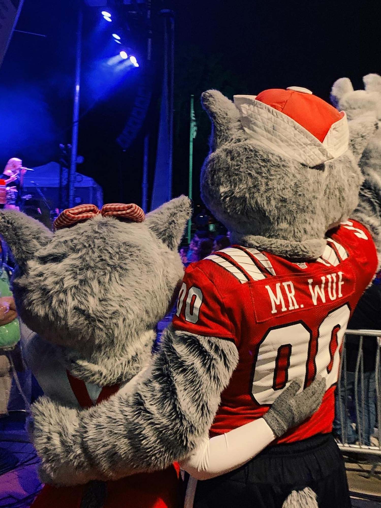 Ms. Wuf and Mr. Wuf throw up their paws during the Packapalooza concert.