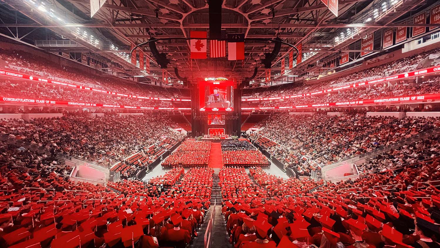 A sea of red caps in PNC Arena for graduation.