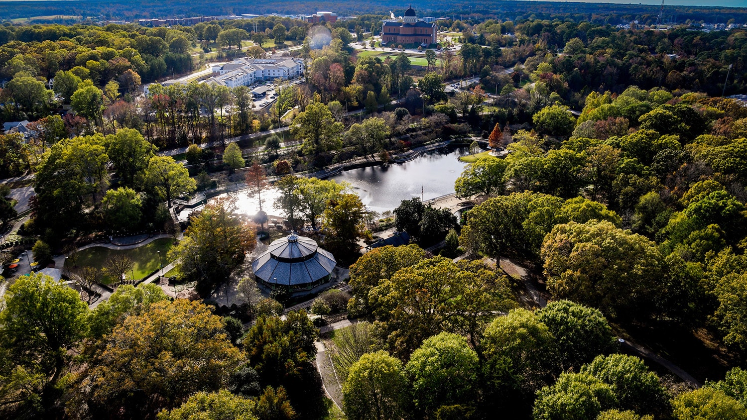 An aerial view of nearby Pullen Park on a sunny day.