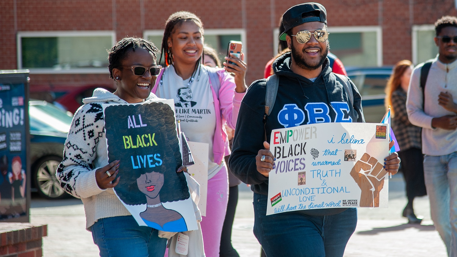Students hold up posters at the March Like Martin 2023 event.