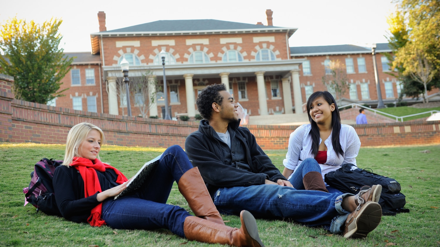 Students share conversation while sitting in the Court of Carolinas in front of the 1911 building.