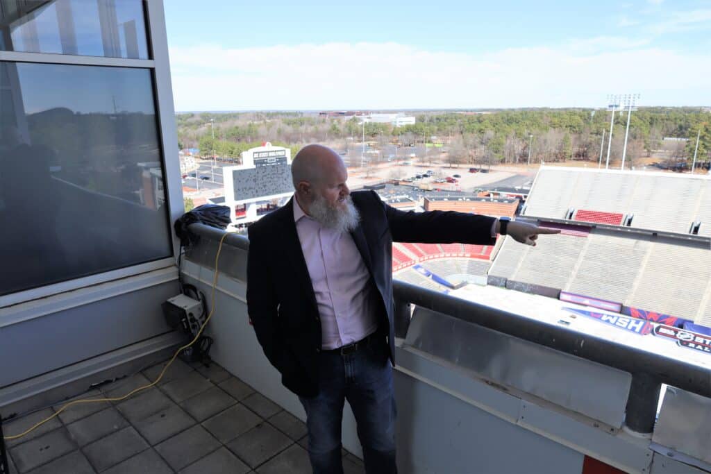 Meteorologist Nate Johnson scopes out conditions at Carter-Finley ahead of the NHL Stadium Series game.
