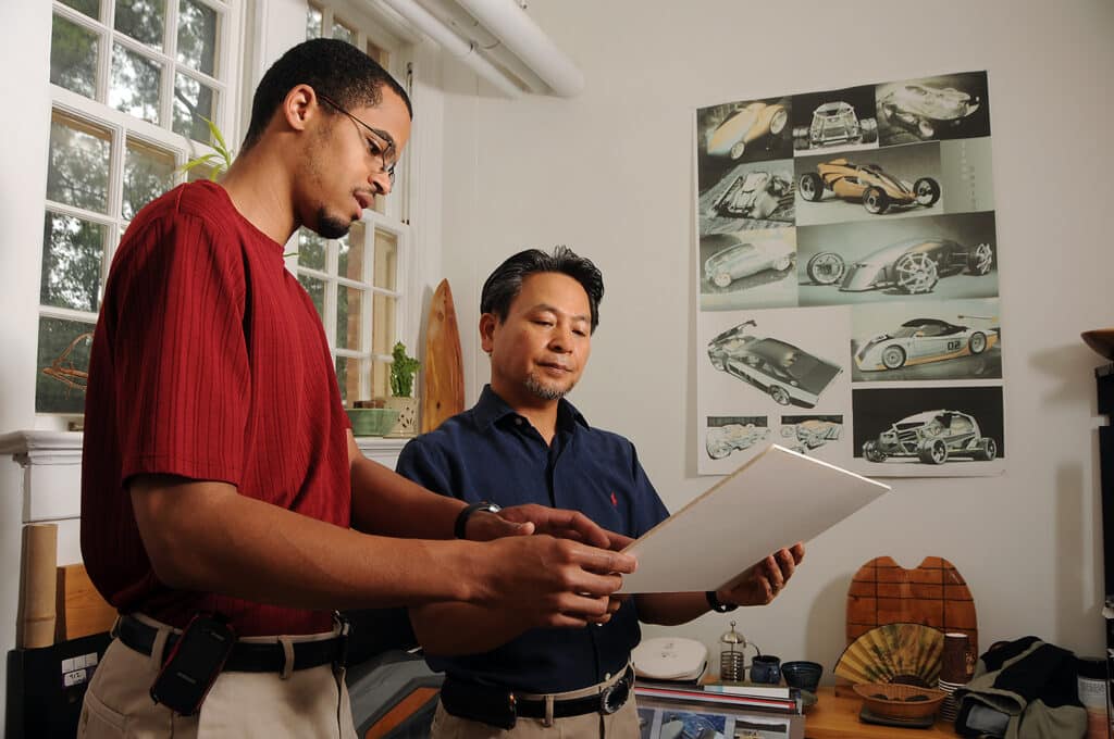 Sean Coleman, left, shows some of his designs to professor Bong Il Jin in his Leazer Hall studio.