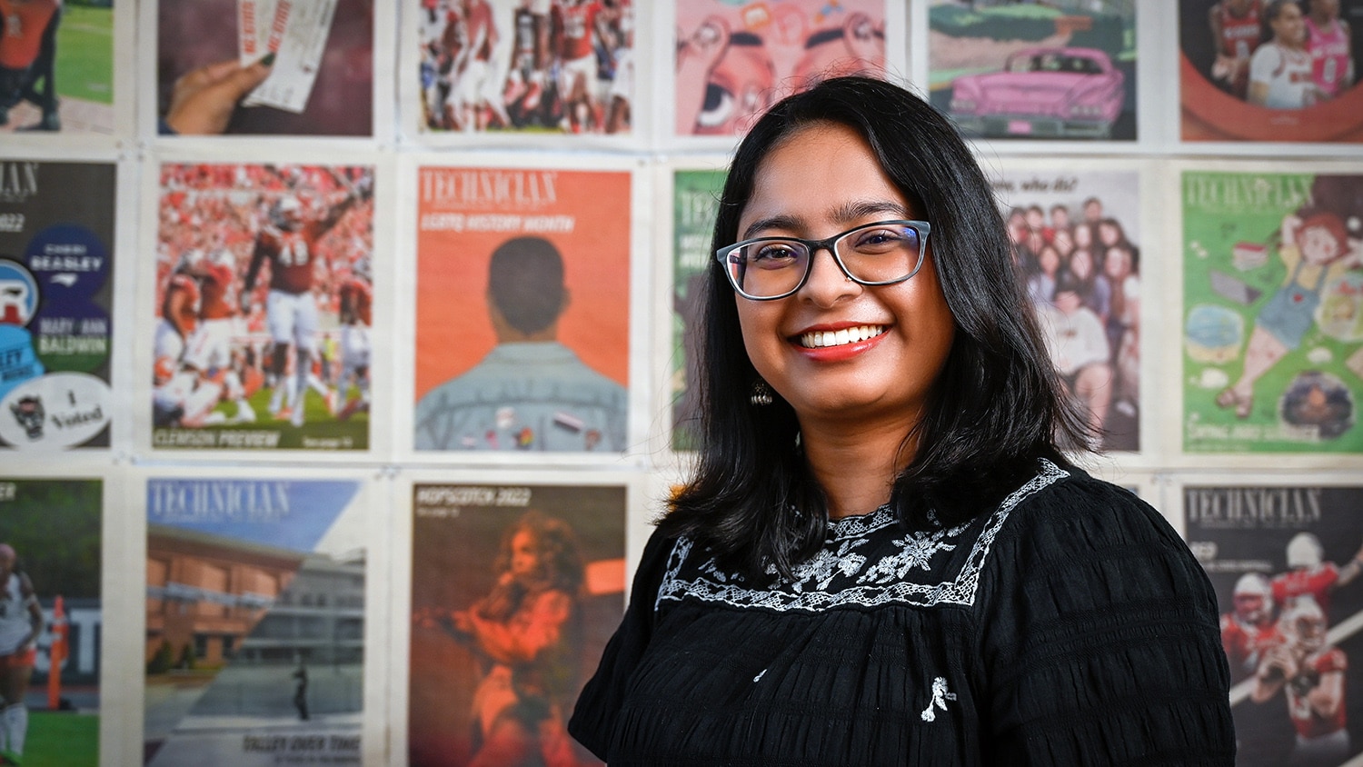 Portrait of Shilpa Giri in front of a wall of Technician covers.