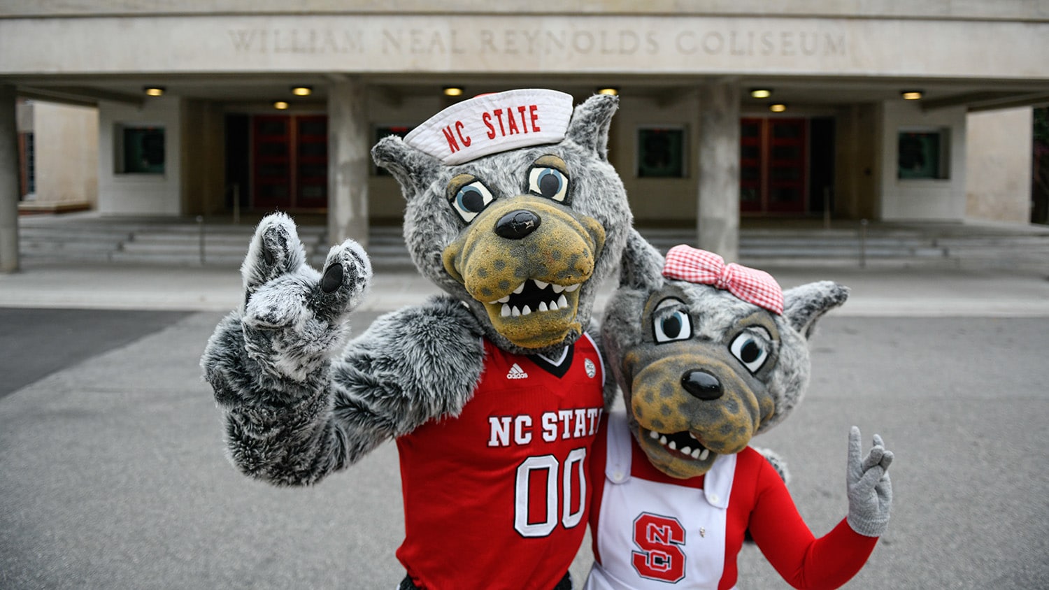 Mr. and Mrs. Wuf in front of Reynolds Coliseum