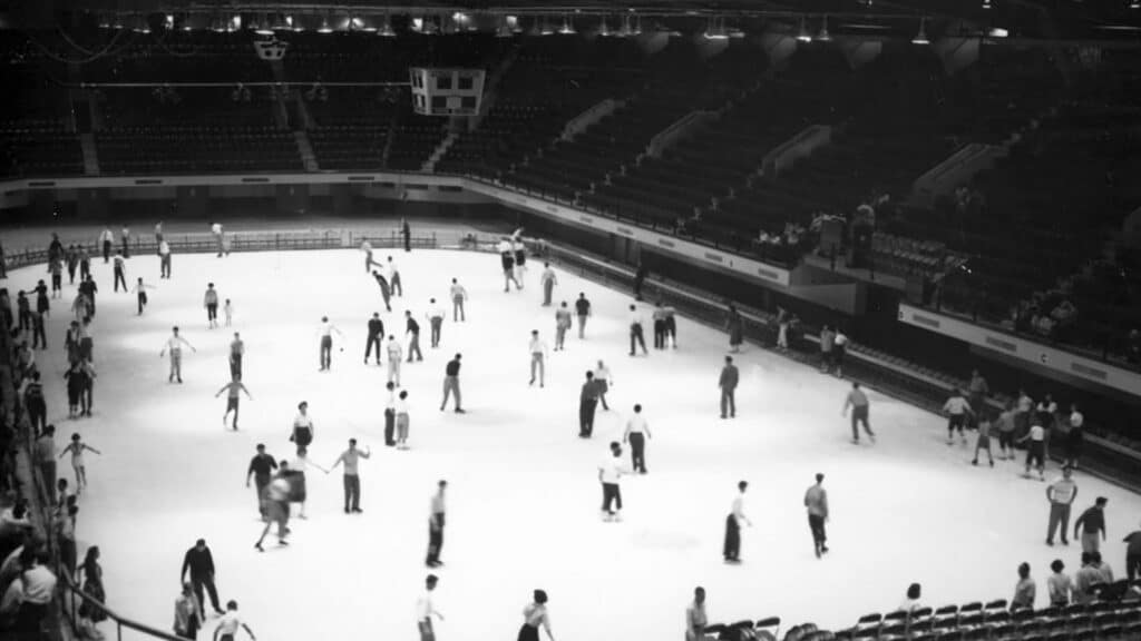 An archival photo shows a crowd of skaters in Reynolds Coliseum enjoying a public skate day.