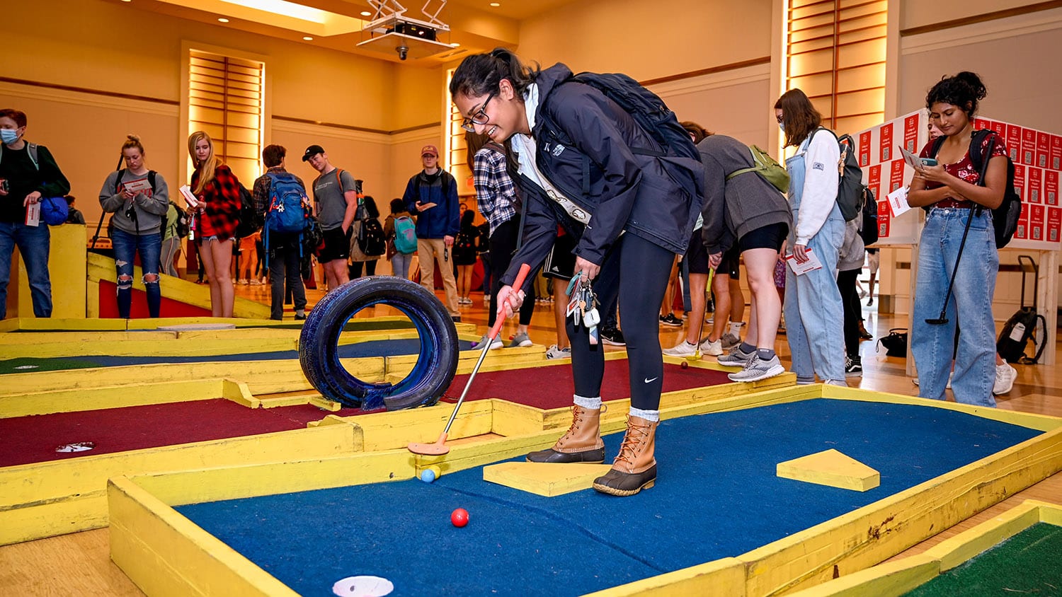 A student plays mini golf at the 2022 Day of Giving student event