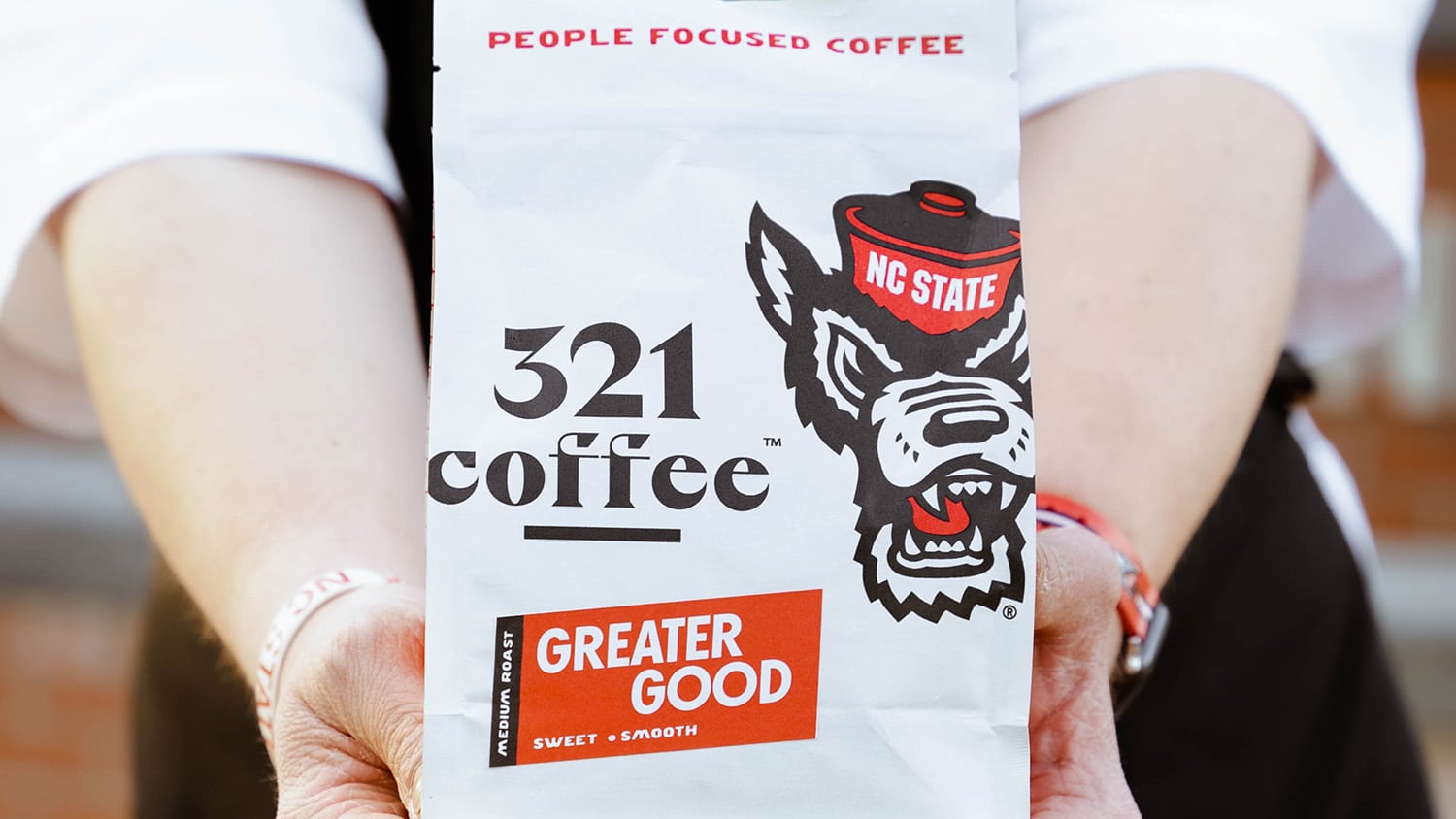 A 321 Coffee employee holds up a bag of Greater Good coffee