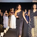 Ritika Shamdasani and her sister Niki, walk on a runway at a Sani fashion show.