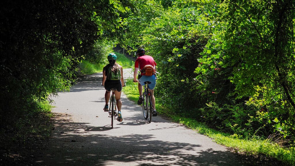 Bicyclists ride along paved trails near Lake Raleigh, which offers an ideal spot for outdoor recreation on NC State's Centennial Campus.