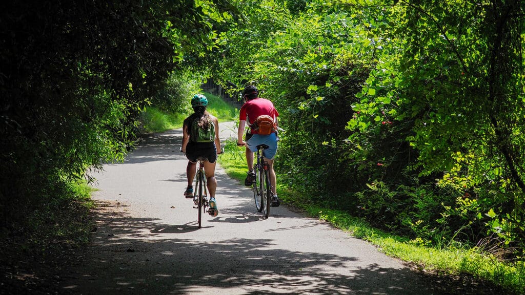 Bicyclists ride along paved trails near Lake Raleigh, which offers an ideal spot for outdoor recreation on NC State's Centennial Campus.