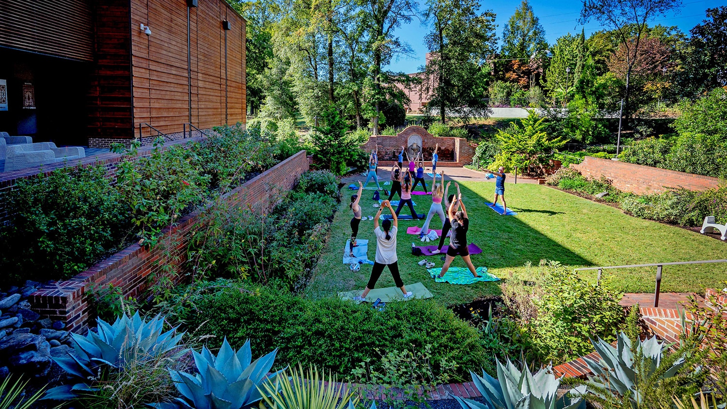 A yoga class in the gardens of the Gregg Museum of Art & Design.