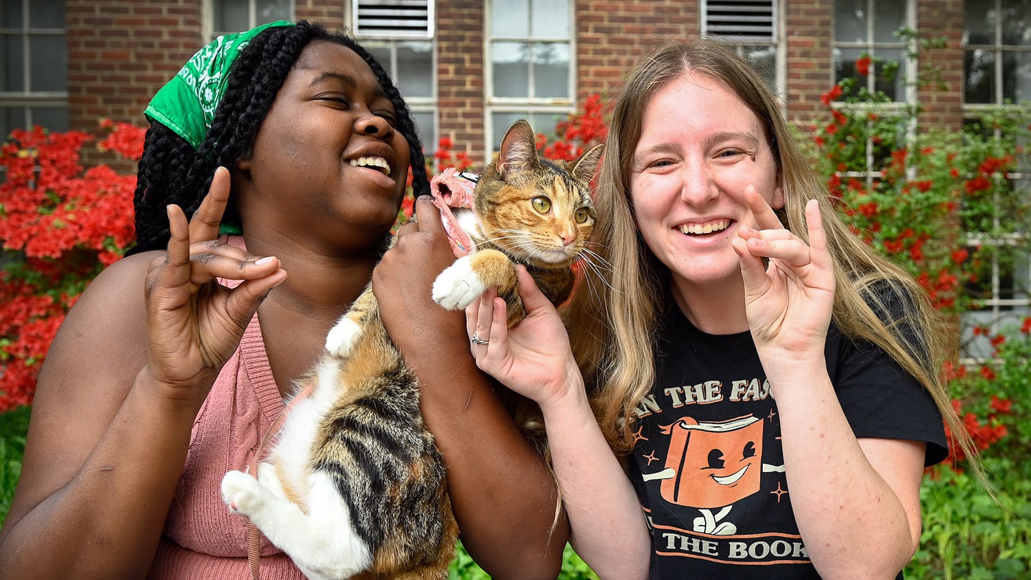 Students bring their cat, Maple, to enjoy the sights on NC State's campus.