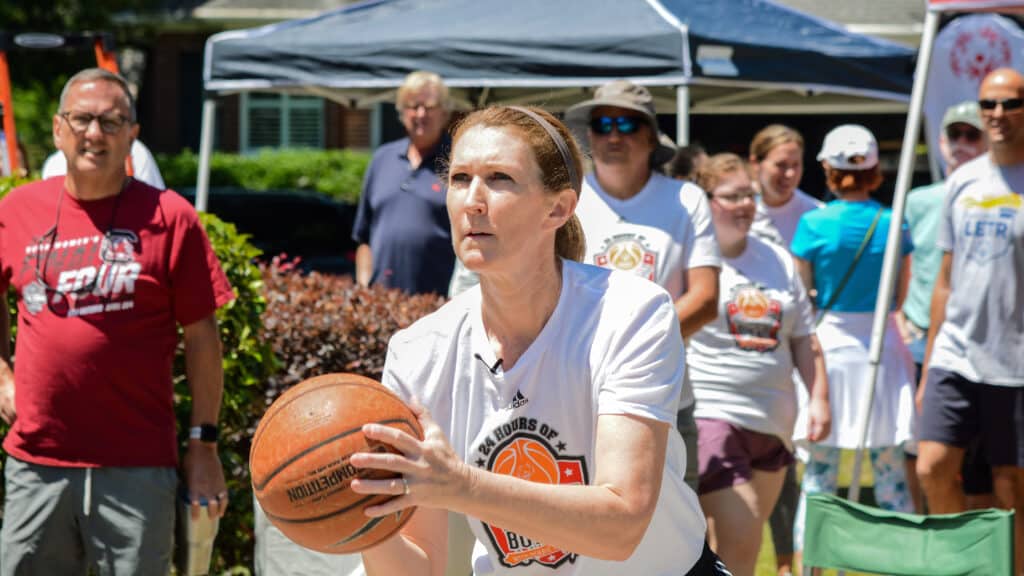 Debbie Antonelli shoots a free throw in her driveway