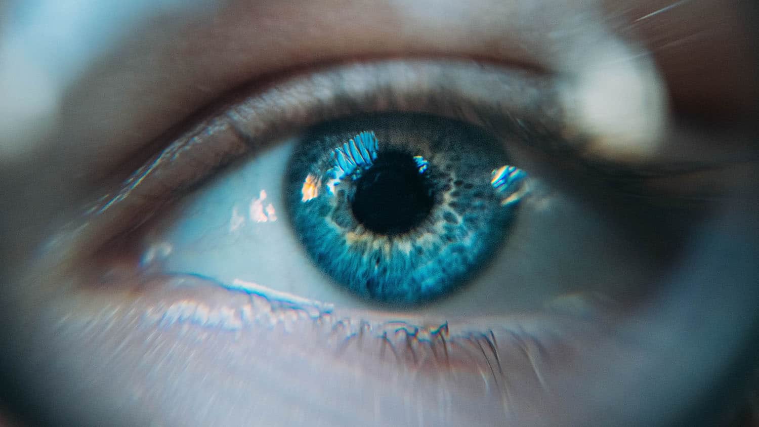close shot of a human eye reflecting light