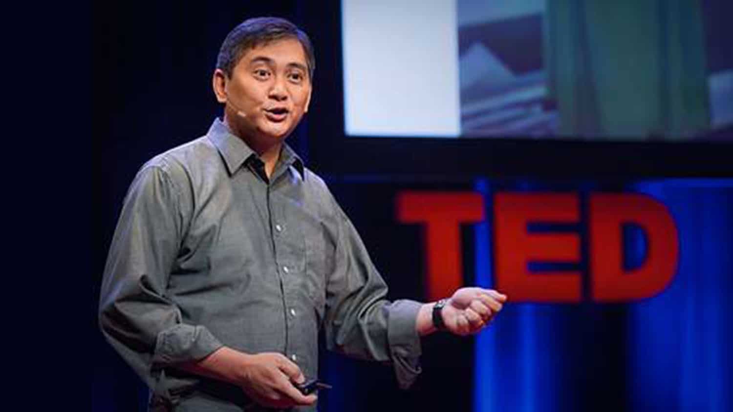 Dr. Francis de los Reyes stands on a stage addressing listeners for a TED Talk on "Sanitation as a Basic Human Right."