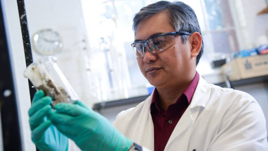 Dr. Francis de los Reyes holds a sample in his lab, where he works to help developing countries deal with sewage issues.