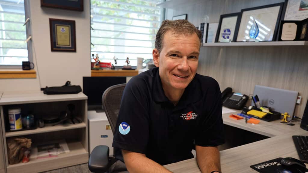 Jamie Rhome at work, with a few Wolfpack trinkets decorating his office.