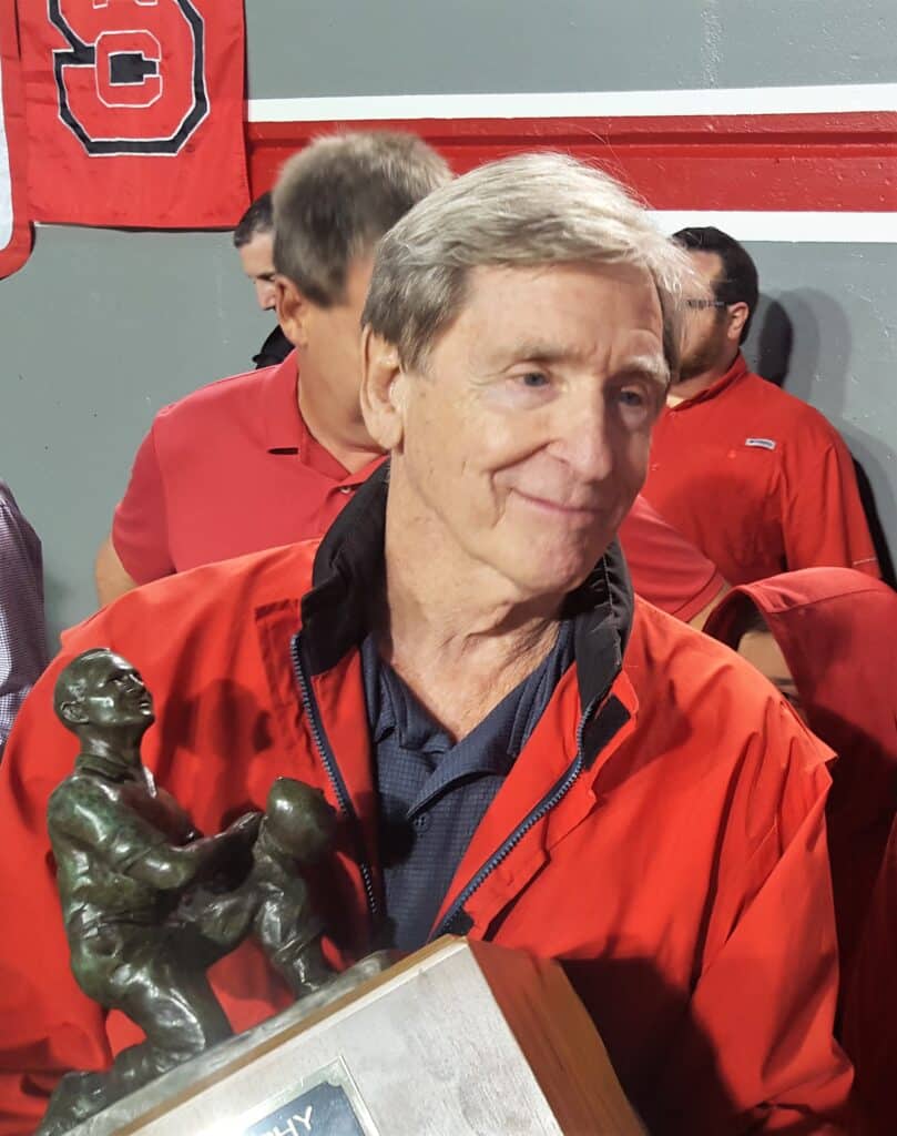 Sheridan on the sidelines holding his trophy for the College Football Hall of Fame