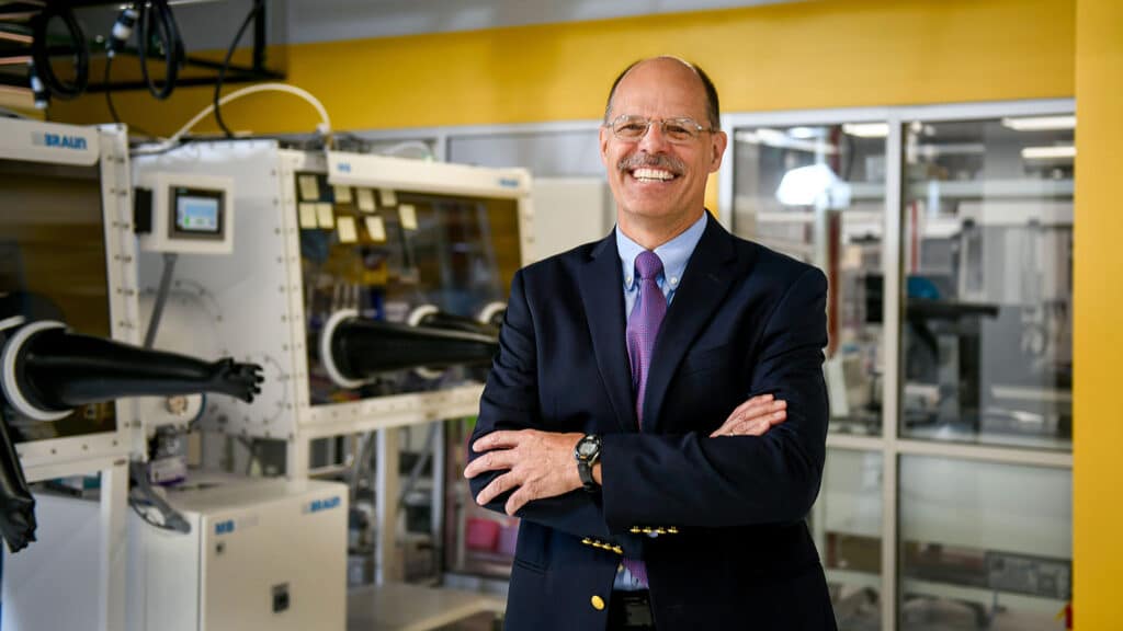 Harald Ade, a Goodnight Innovation Distinguished Professor in the Department of Physics and a coordinator for the Carbon Electronics cluster, poses in front of equipment in the ORaCEL facilities on Centennial Campus.