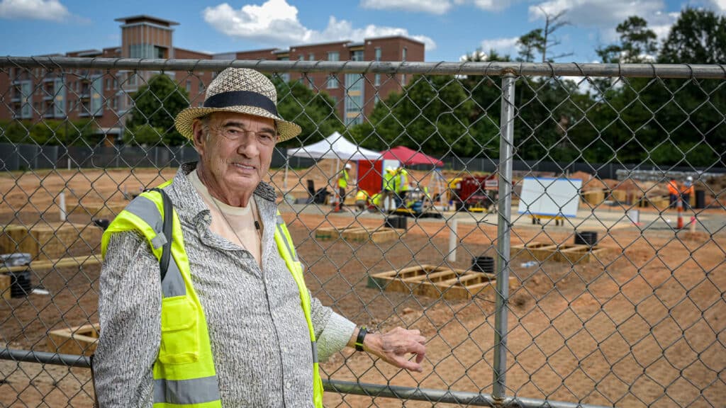 Artist Larry Bell stands near the construction site as Reds and Whites is installed on Centennial Campus.