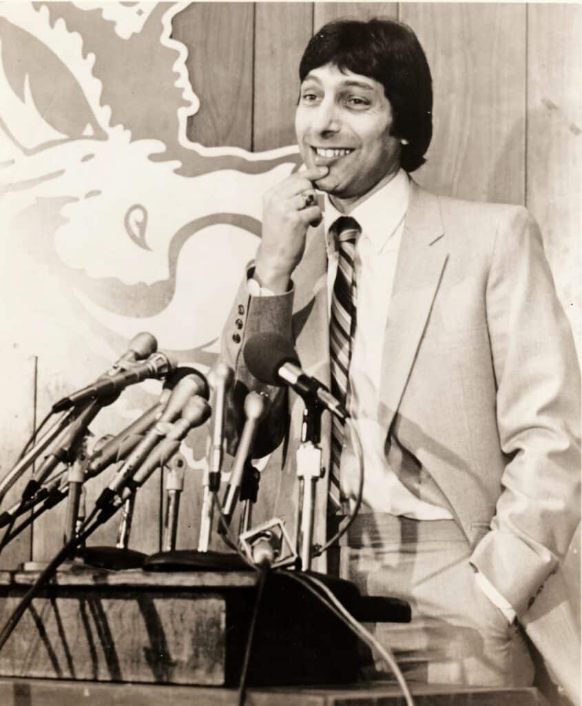Valvano at the podium for a press conference on his first day as head coach of NC State's men's basketball team