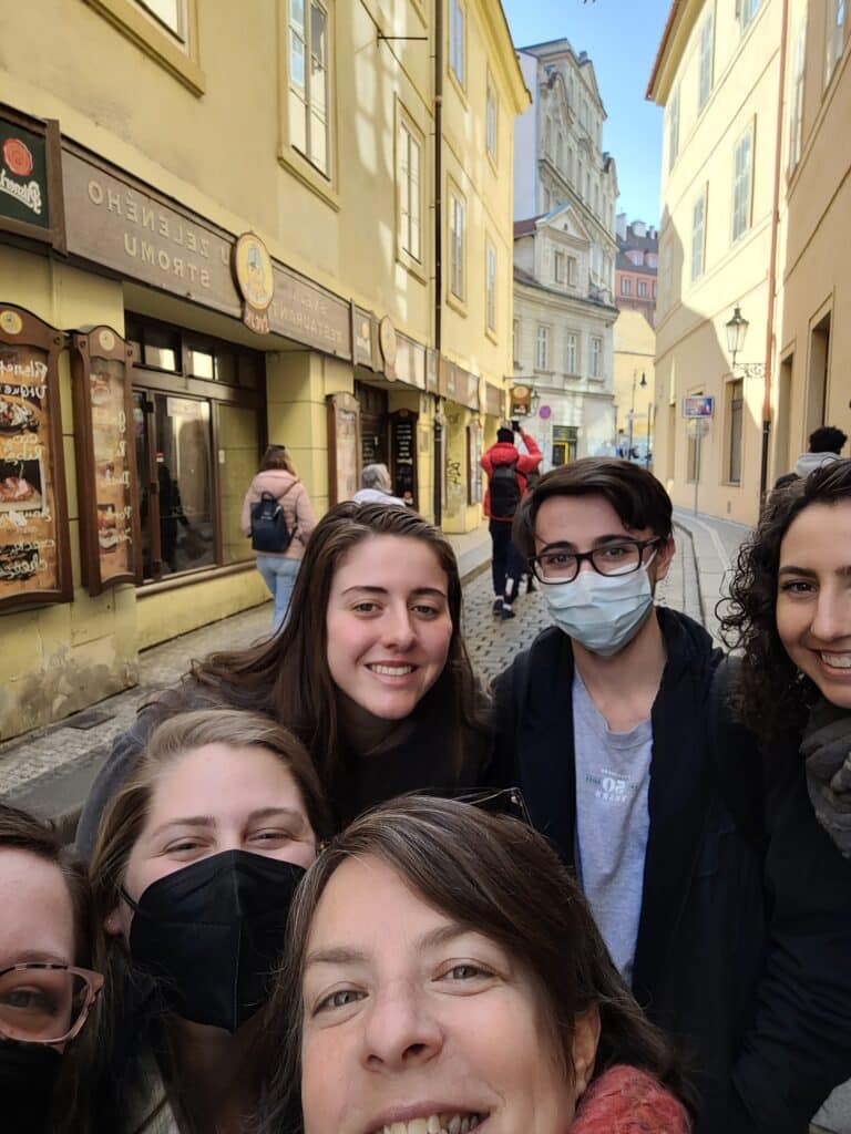 Hurlburt, her students and Catherine Showalter, associate director of the Office of Undergraduate Research, take a selfie on a street in Prague.