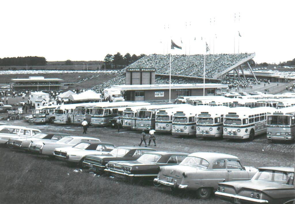 Cars and buses parked outside of Carter Stadium