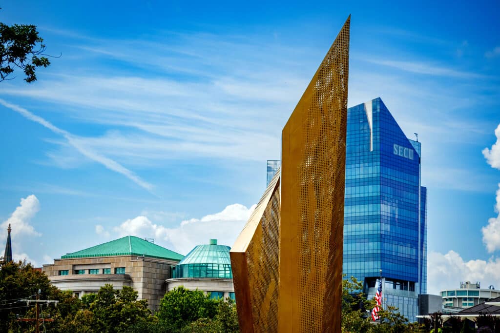 The central beacon in the park, with the SECU building in downtown Raleigh in the background