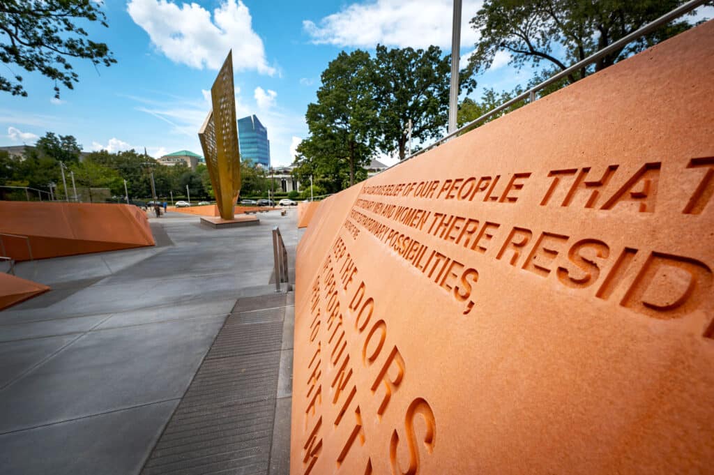 An inscription on one of the orange walls surrounding the central beacon in the park